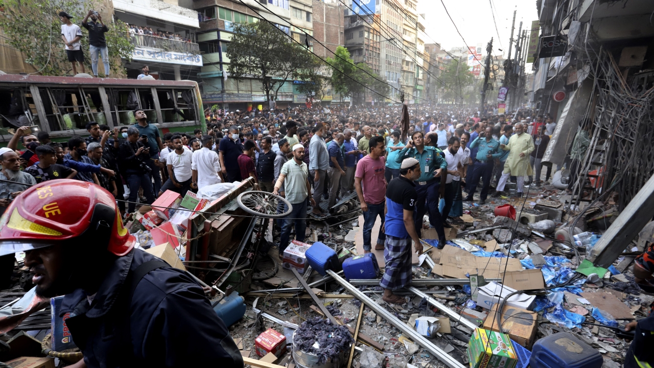 Onlookers gather outside the site of an explosion in Bangladesh.