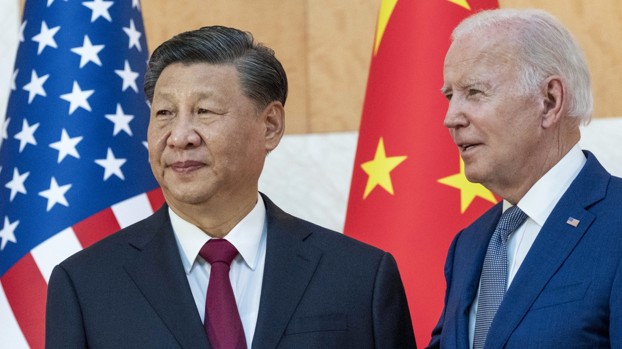 U.S. President Joe Biden, right, stands with Chinese President Xi Jinping.