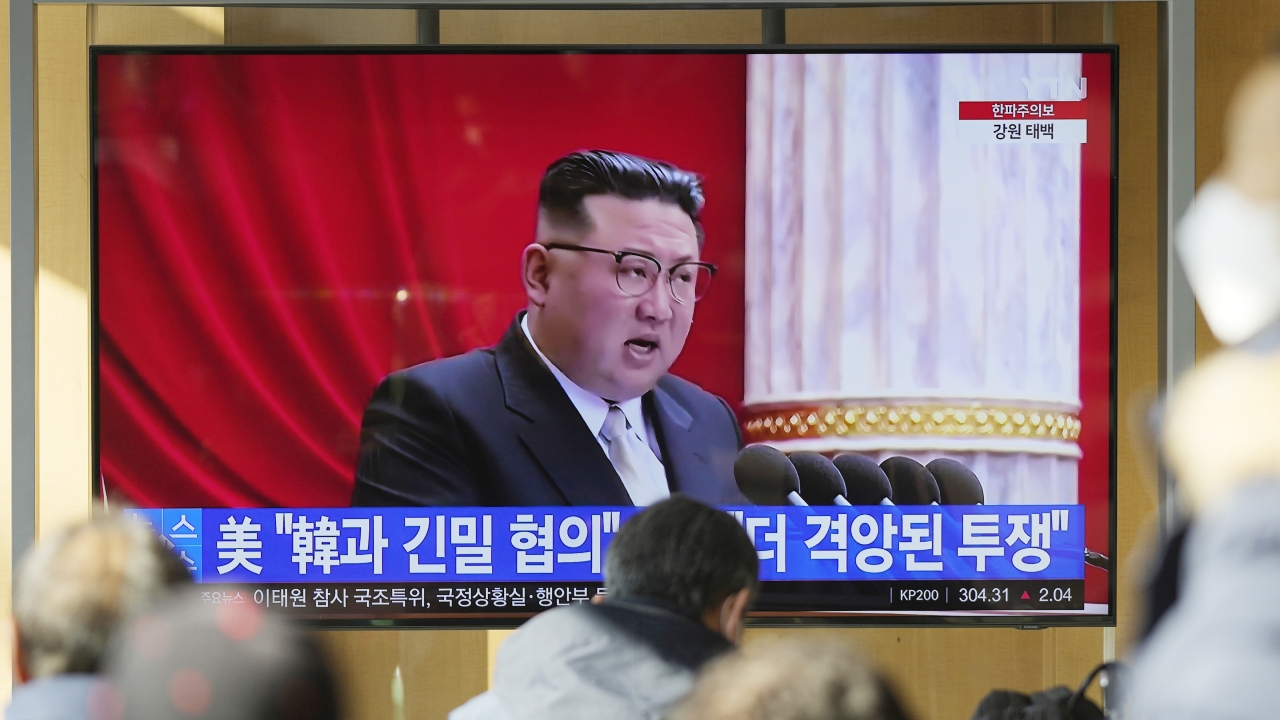 A TV screen shows footage of North Korean leader Kim Jong Un.