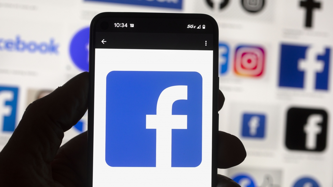 The Facebook logo is seen on a cell phone