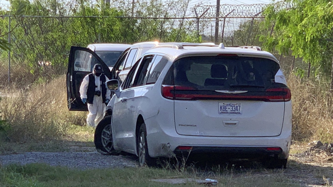 Mexican police investigator inspects the minivan were four Americans where shot and taken