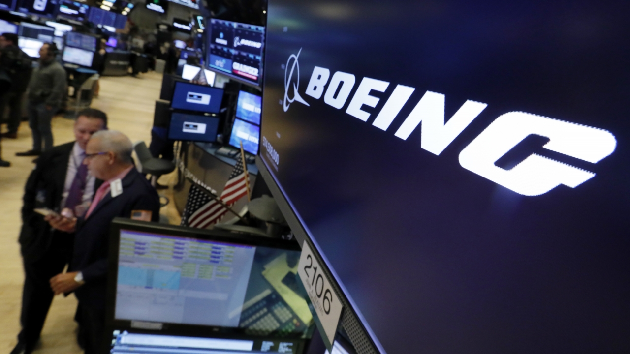 The logo for Boeing appears above a trading post on the floor of the New York Stock Exchange.