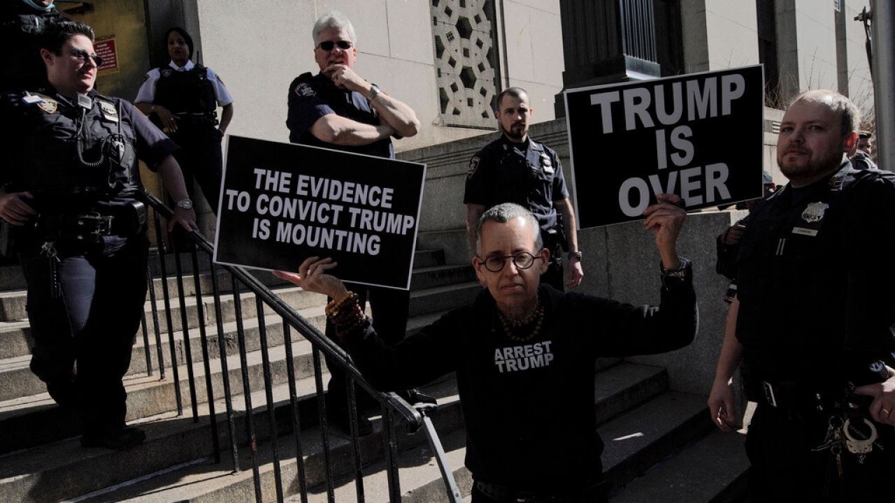 A protester in front of the New York State Court ahead of former President Donald Trump's anticipated indictment.