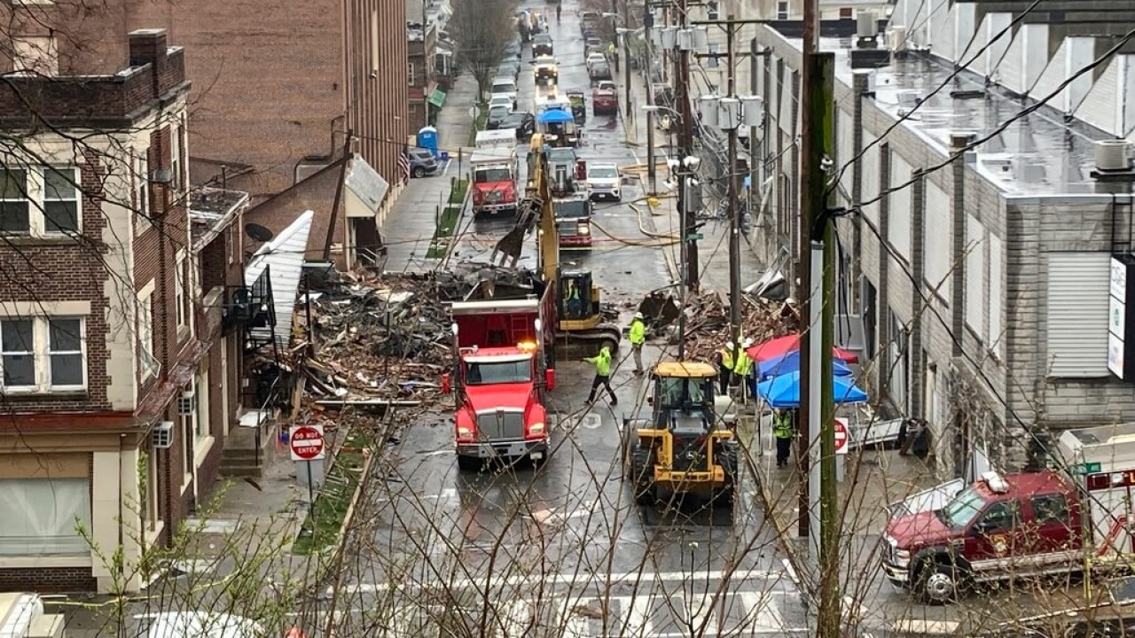 Emergency responders and heavy equipment are seen at the site of a deadly explosion at a chocolate factory.