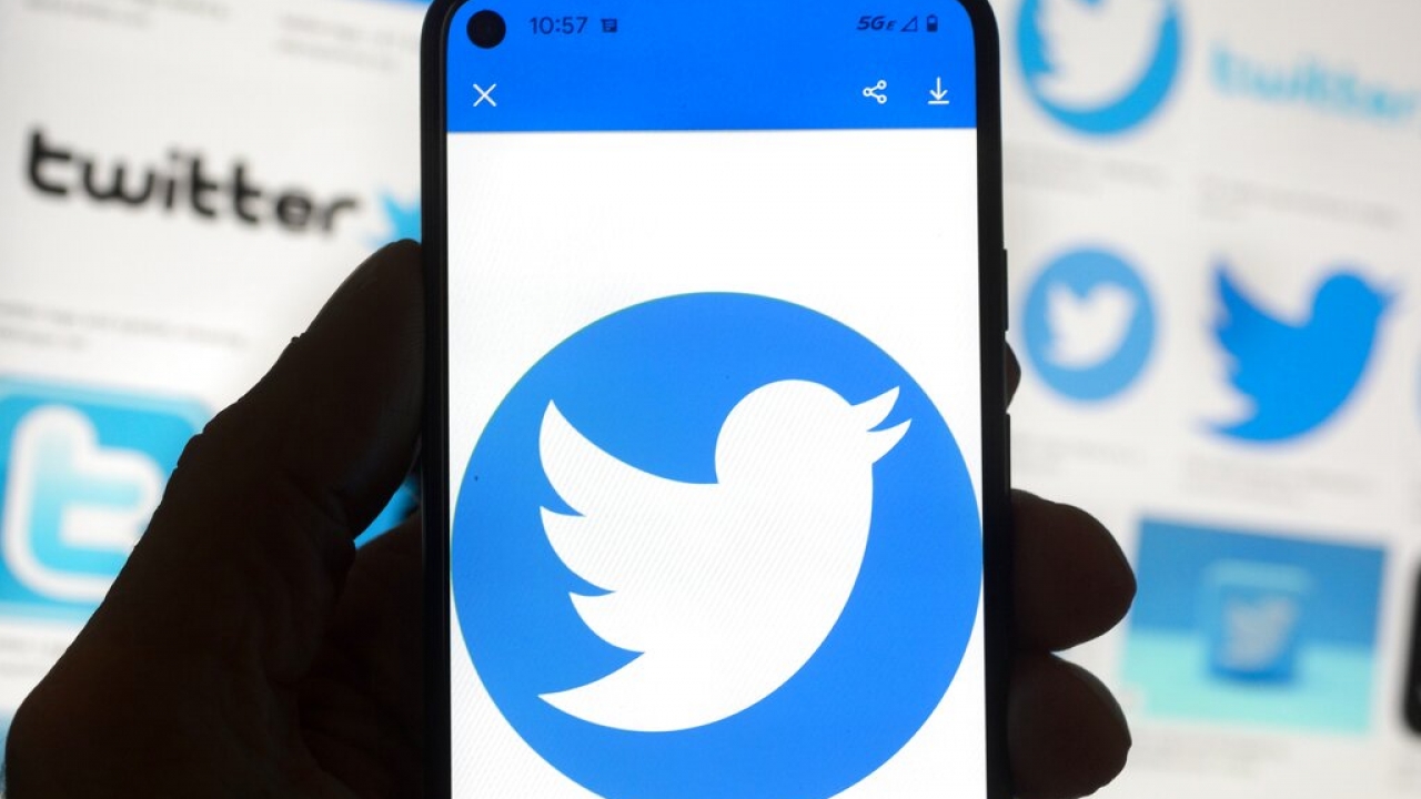 The Twitter logo is seen on a cellphone