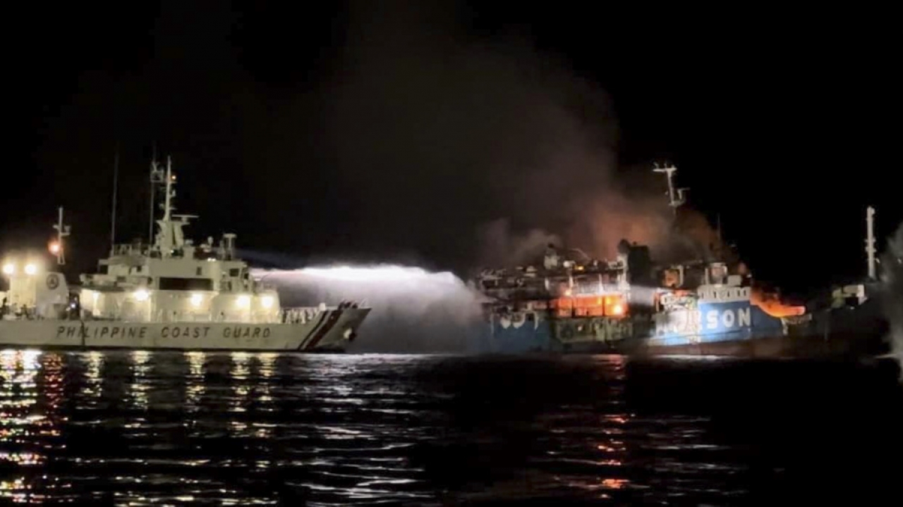 A Philippine Coast Guard ship trains its hose as it tries to extinguish fire on a ferry.