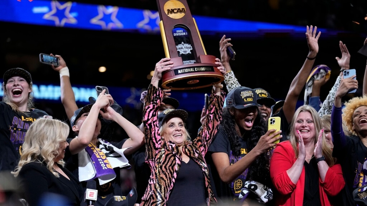 LSU head coach Kim Mulkey holds the winning trophy after the NCAA Women's Final Four championship basketball game.