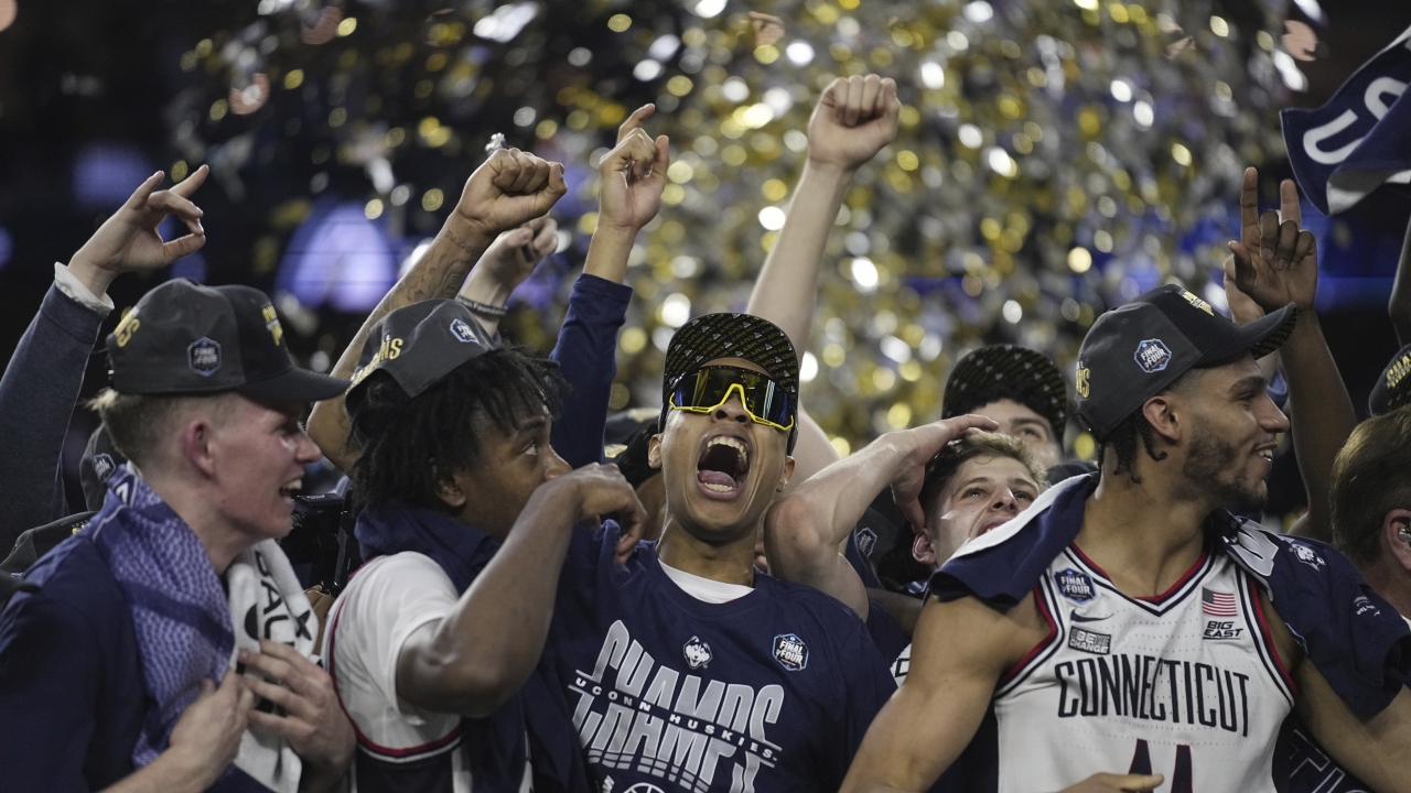 Connecticut players celebrate after winning the men's NCAA national championship basketball game.