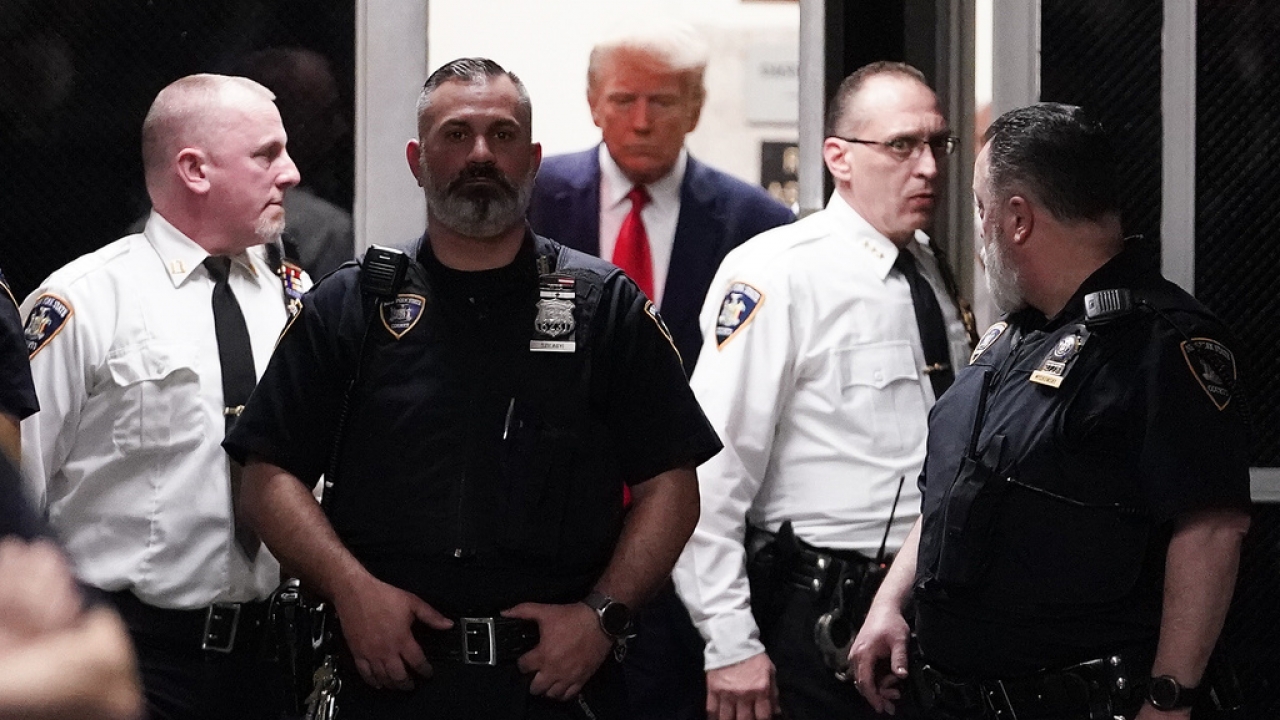 Former President Donald Trump approaches the entrance to a Manhattan courtroom