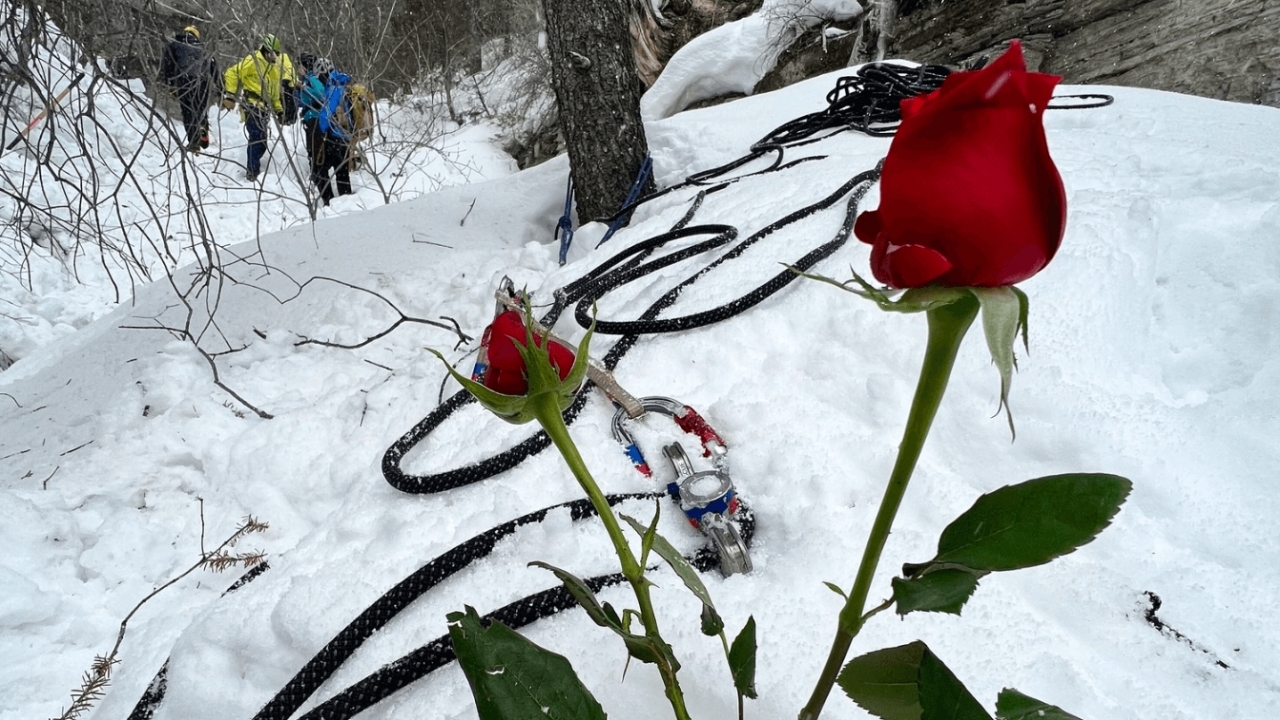 A rose in the snow honors a climber who died.