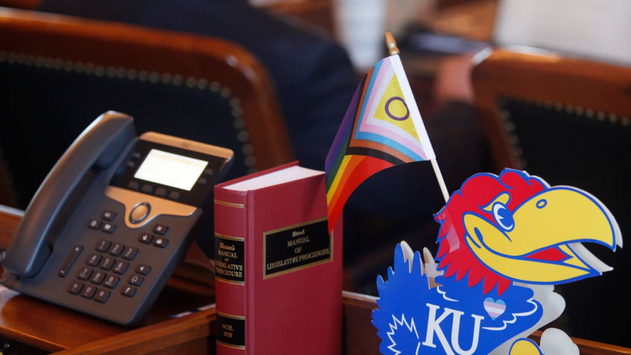 A flag celebrating LGBTQ rights sits on the desk of a Kansas state representative.