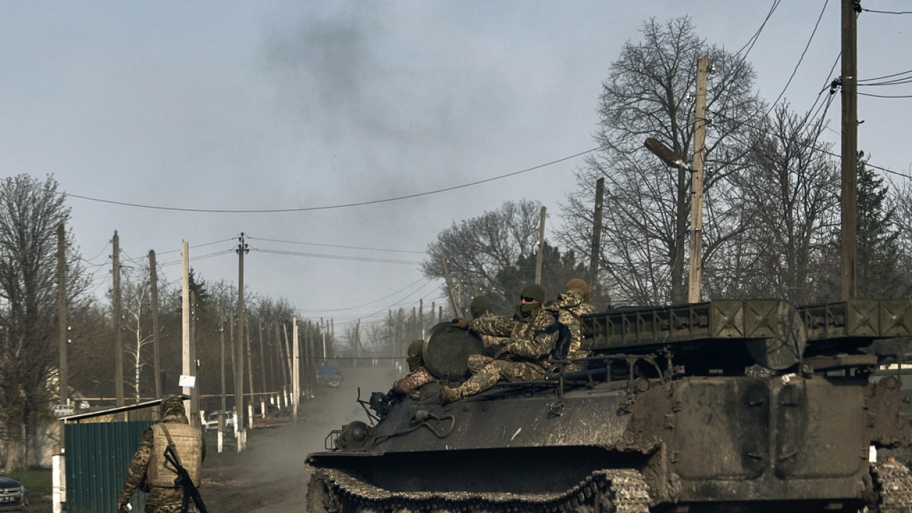 Ukrainian soldiers ride atop an APC in Bakhmut, Donetsk region, Ukraine, April 9, 2023.
