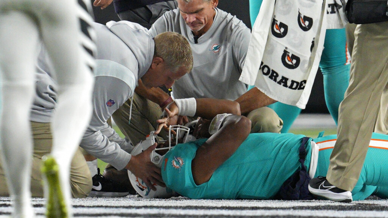 Miami Dolphins quarterback Tua Tagovailoa is examined on the field.