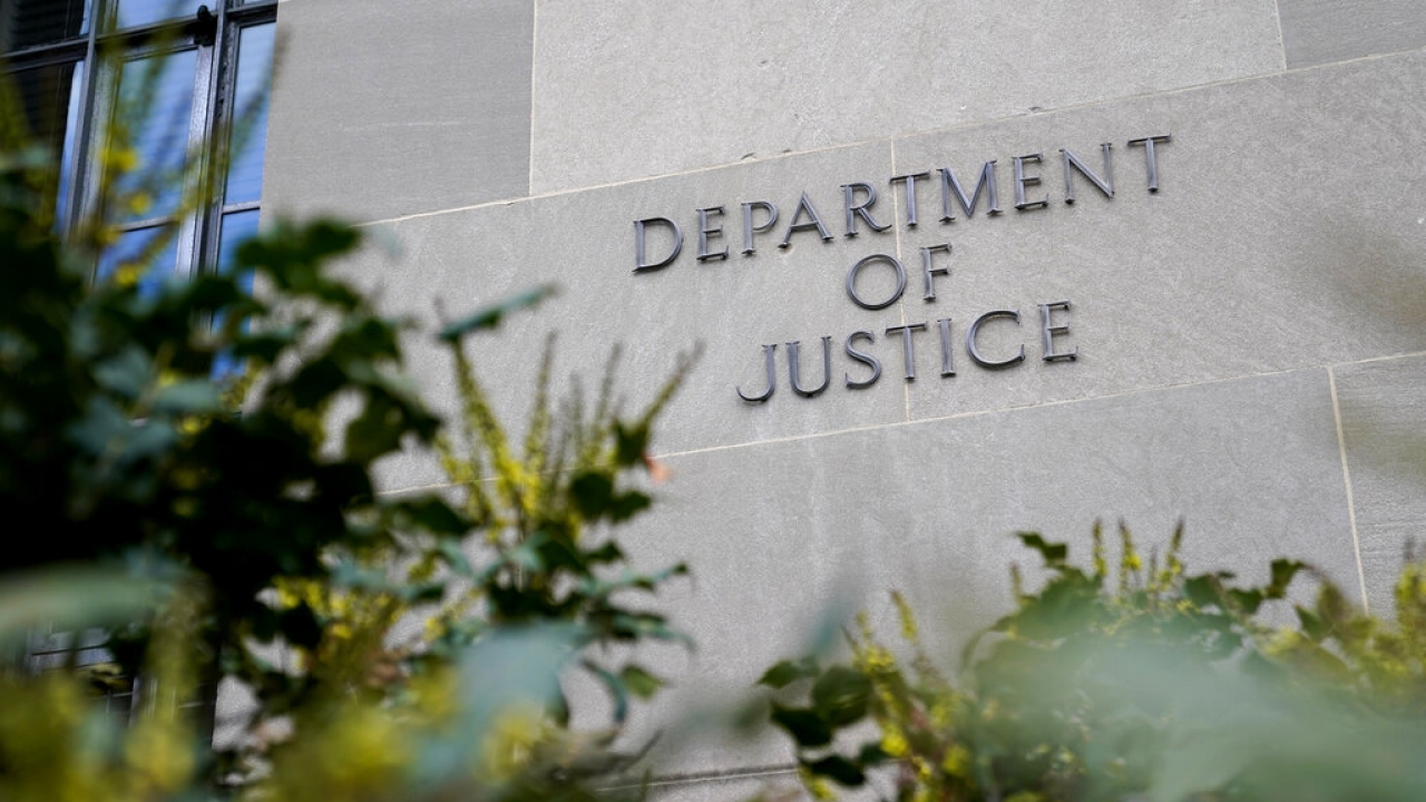 A sign marks an entrance to the Department of Justice Building in Washington.