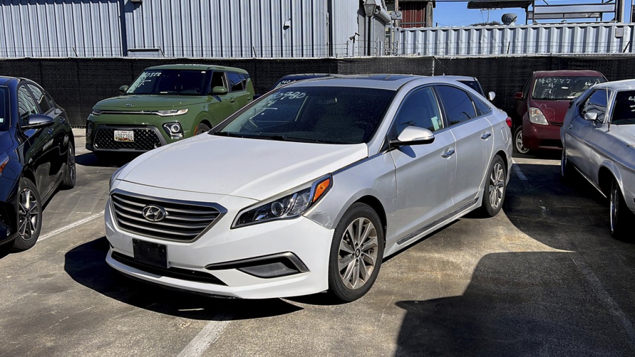 A Hyundai sedan sits in the parking lot of East Bay Tow Inc.