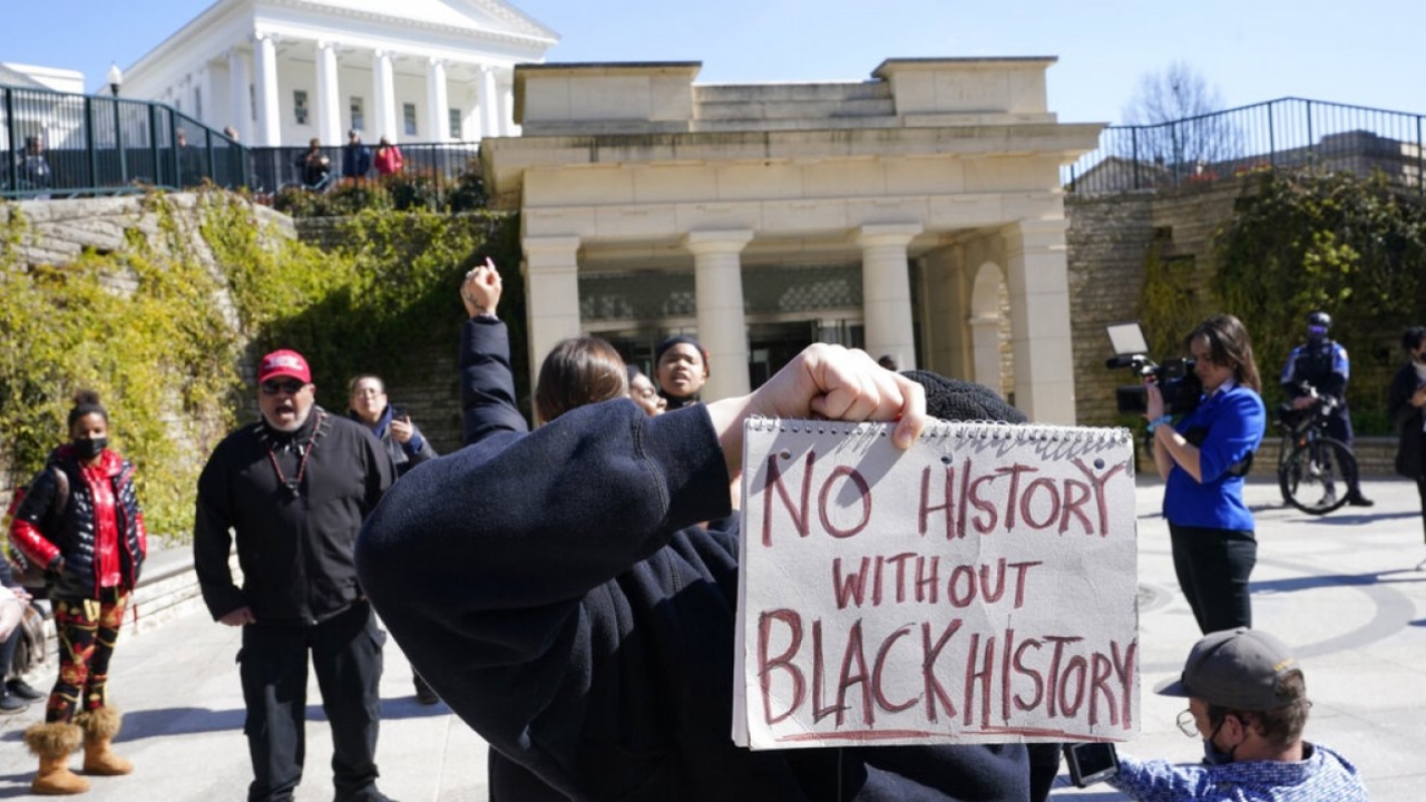 A demonstrator holds a sign that says "No history without Black history" at the state Capitol in Richmond, Virginia.