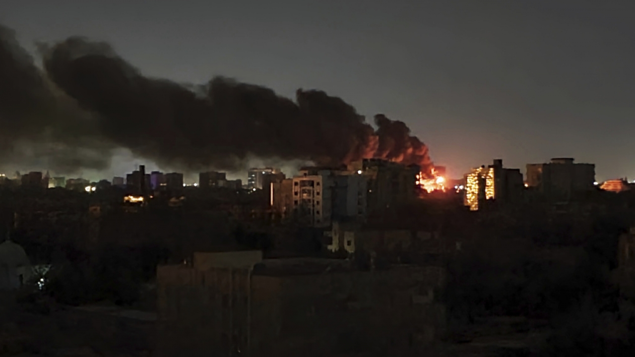 Smoke rises over the horizon as a fire burns in Sudan
