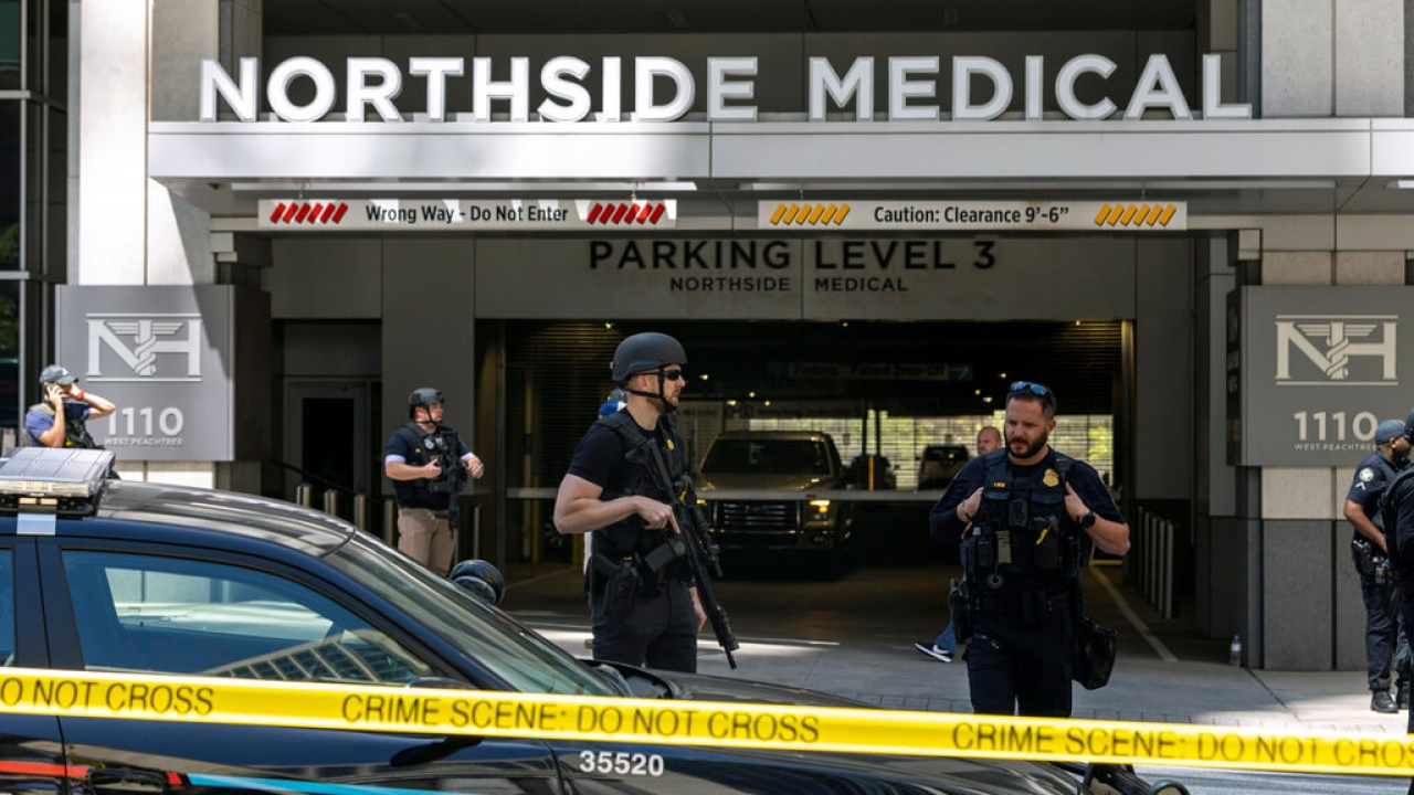 Law enforcement officers stand Northside Hospital Midtown.