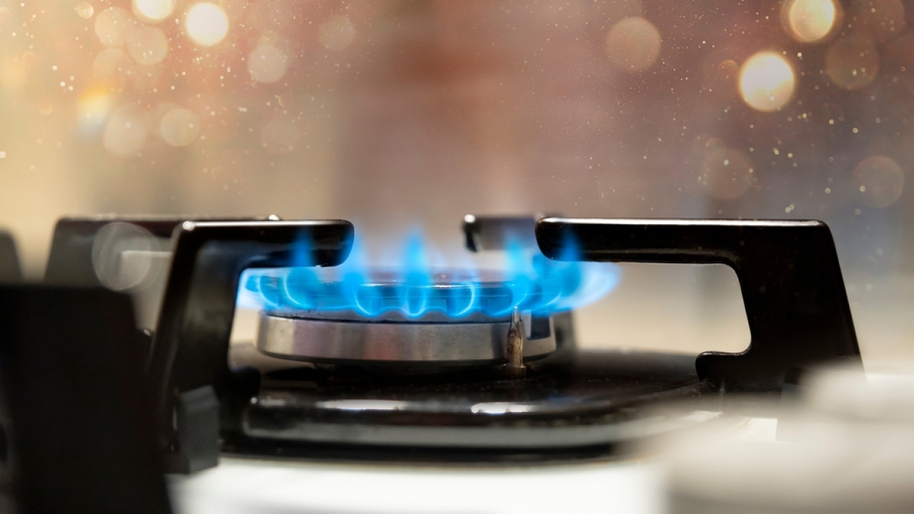 Gas stove producing a blue flame.