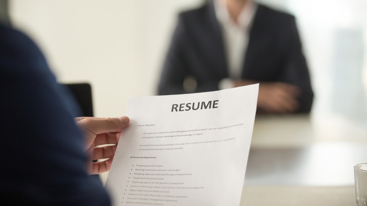 Person holding a resume.