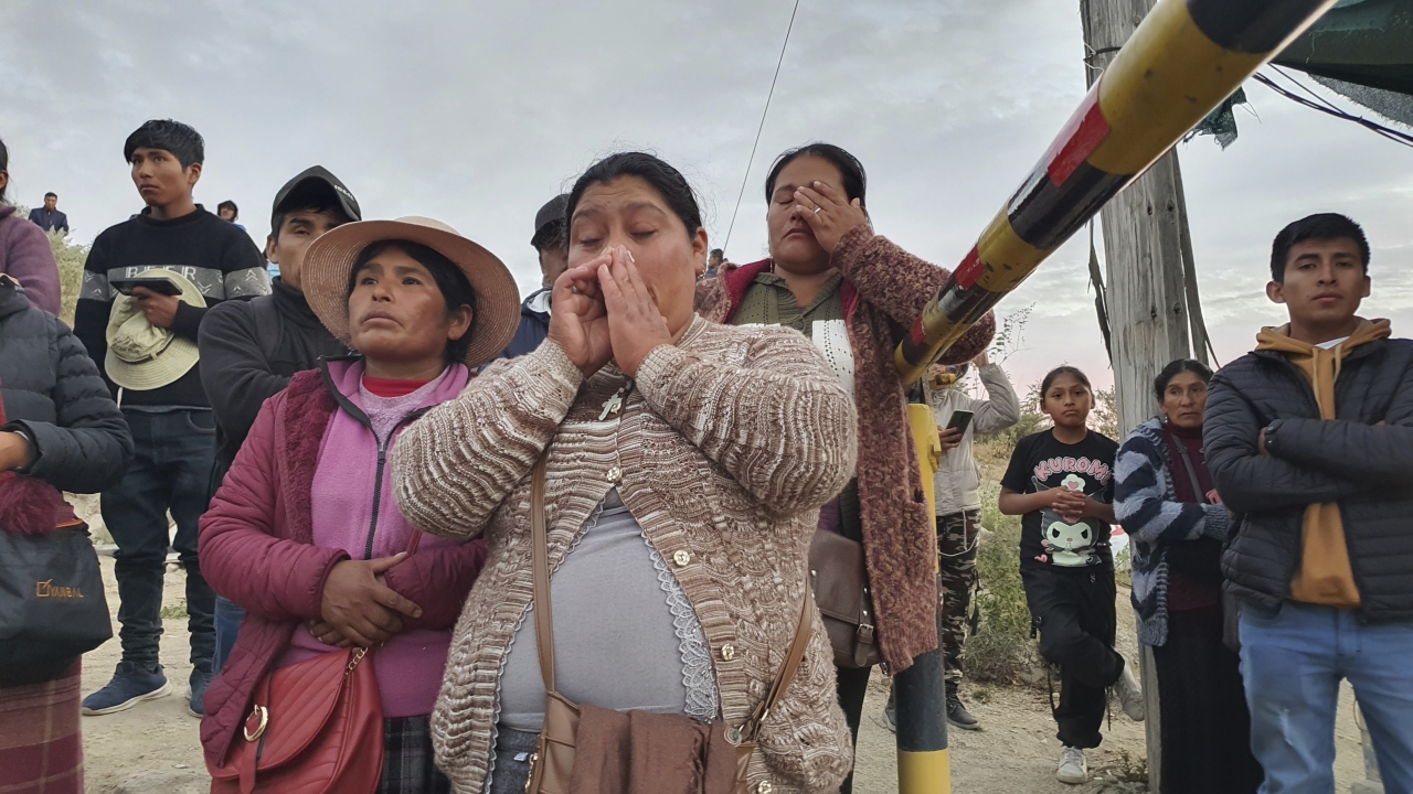 Relatives of trapped miners wait outside the SERMIGOLD mine in Peru.