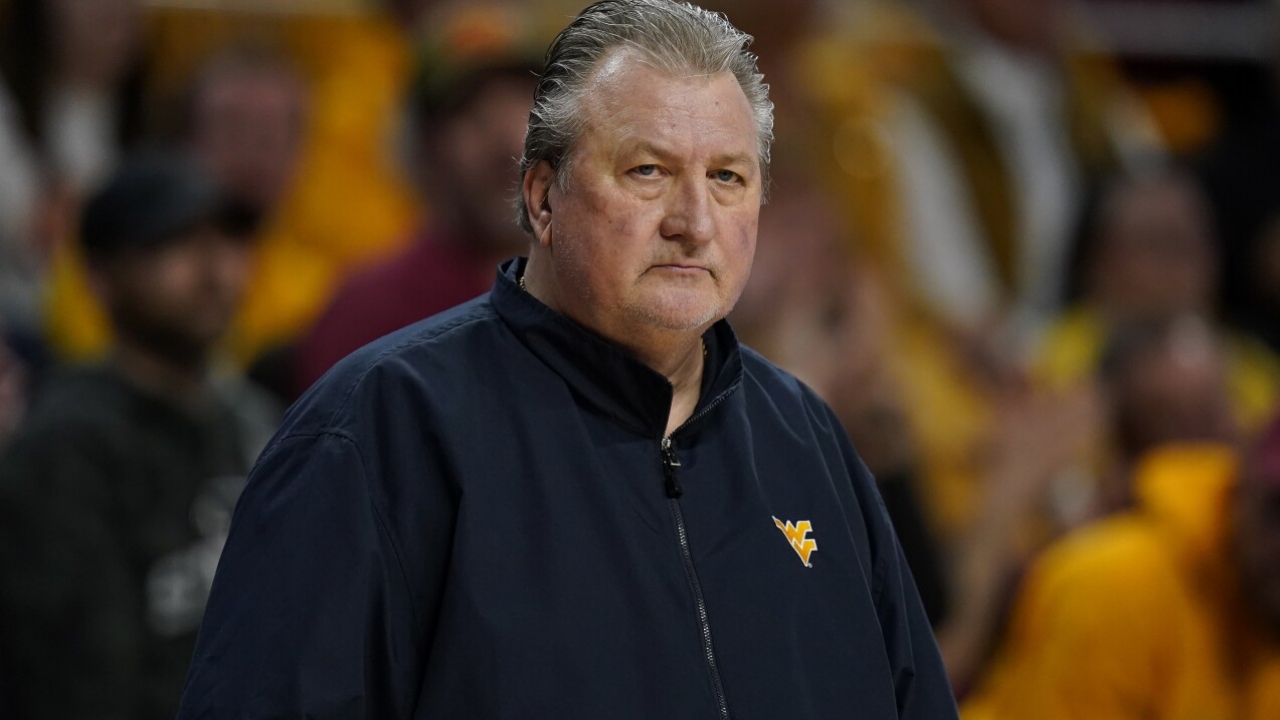West Virginia head coach Bob Huggins watches from the bench during the first half of an NCAA college basketball game.