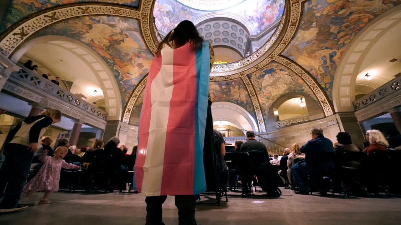 A transgender rights supporter holds a counter-protest at the Missouri Statehouse.