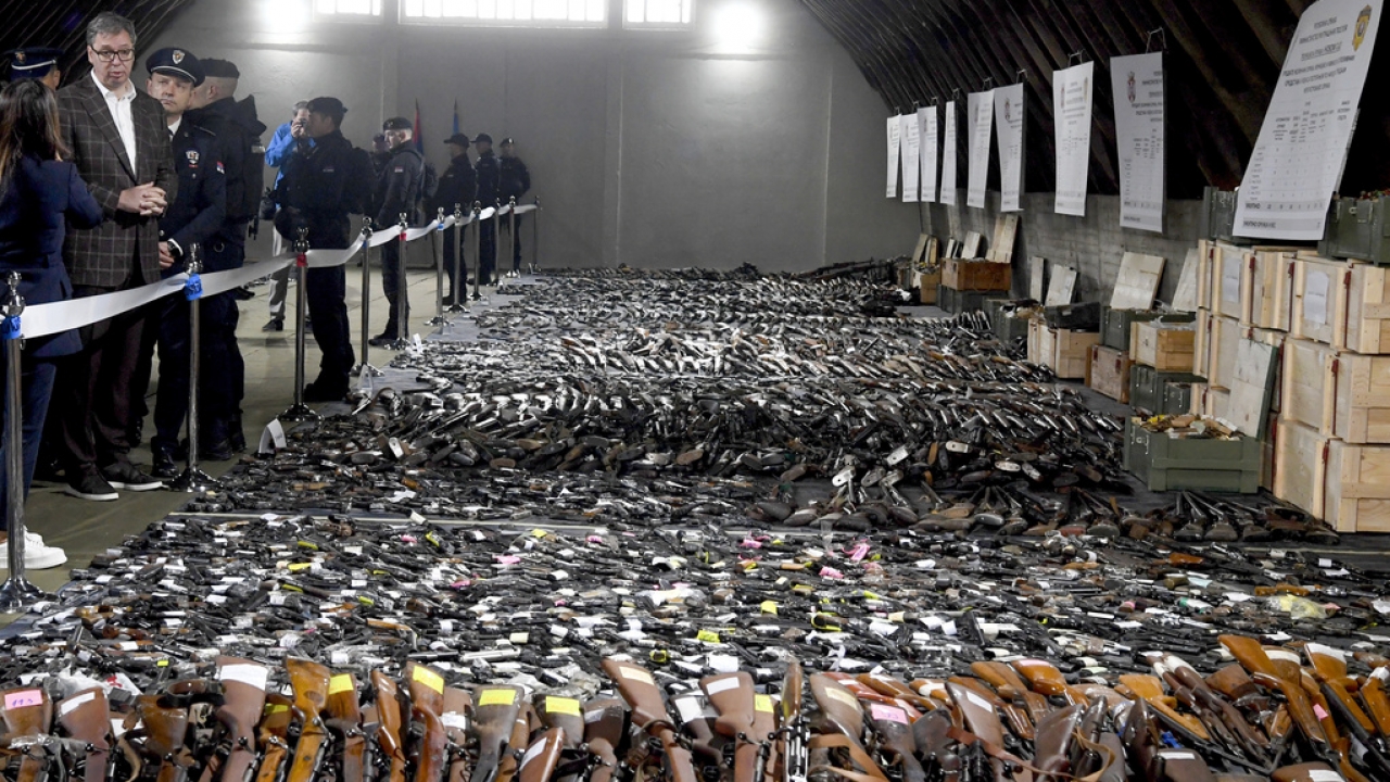 Serbian President Aleksandar Vucic inspects weapons collected as part of an amnesty
