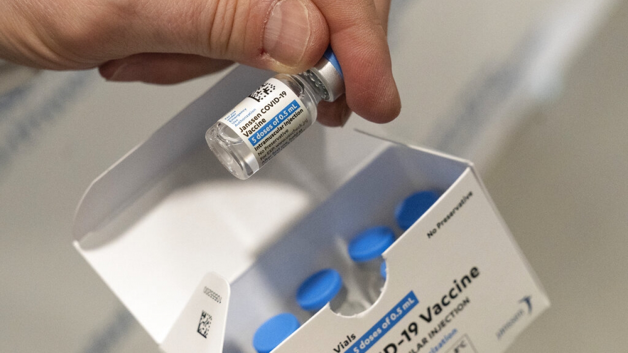 A pharmacist holds a vial of the Johnson & Johnson COVID-19 vaccine.