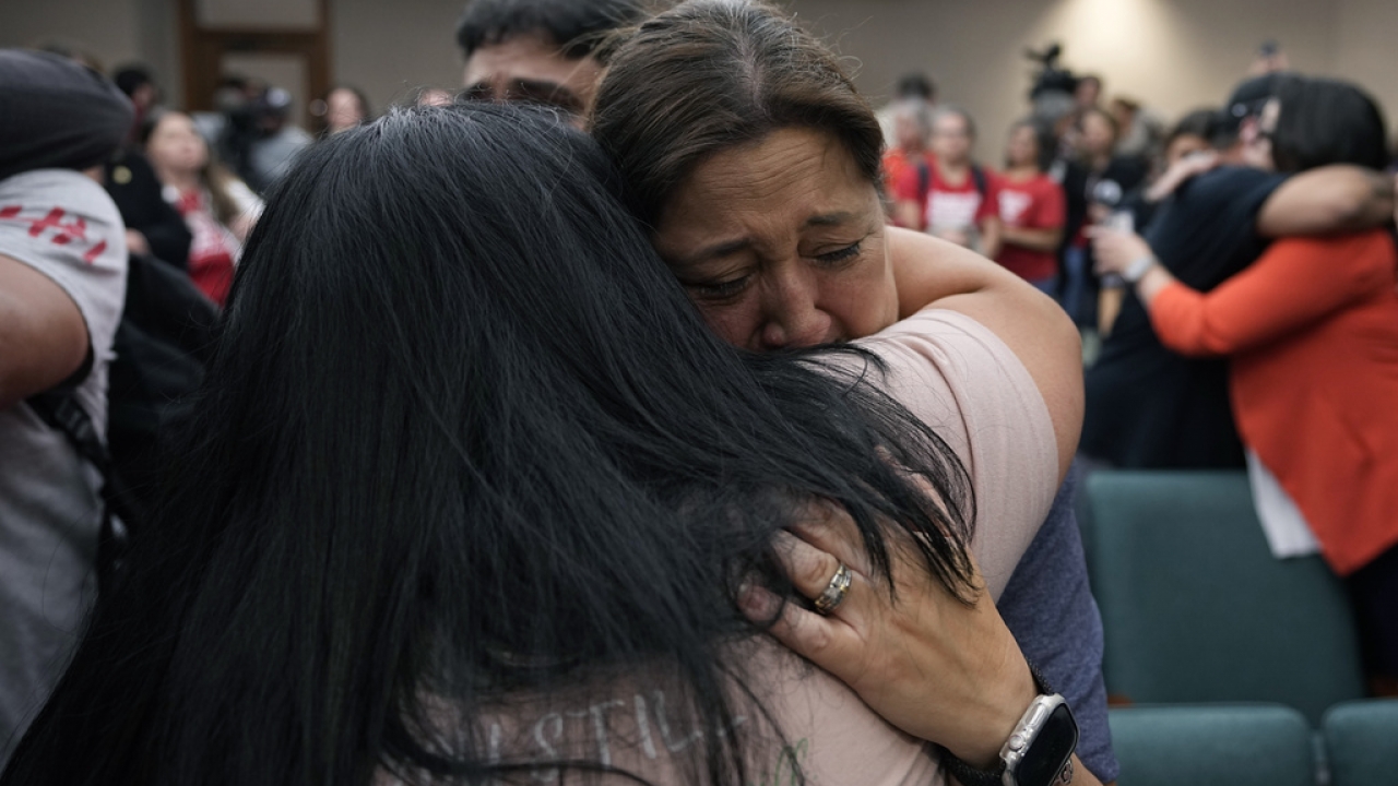 Mourners of the Uvalde school shooting embrace