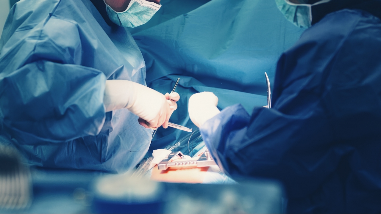 Health professionals perform surgery.