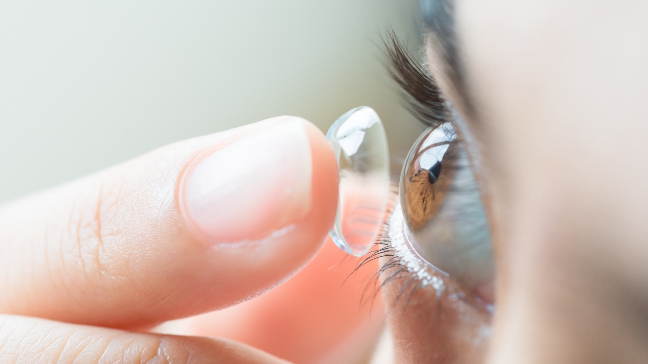 Person applying a contact lens