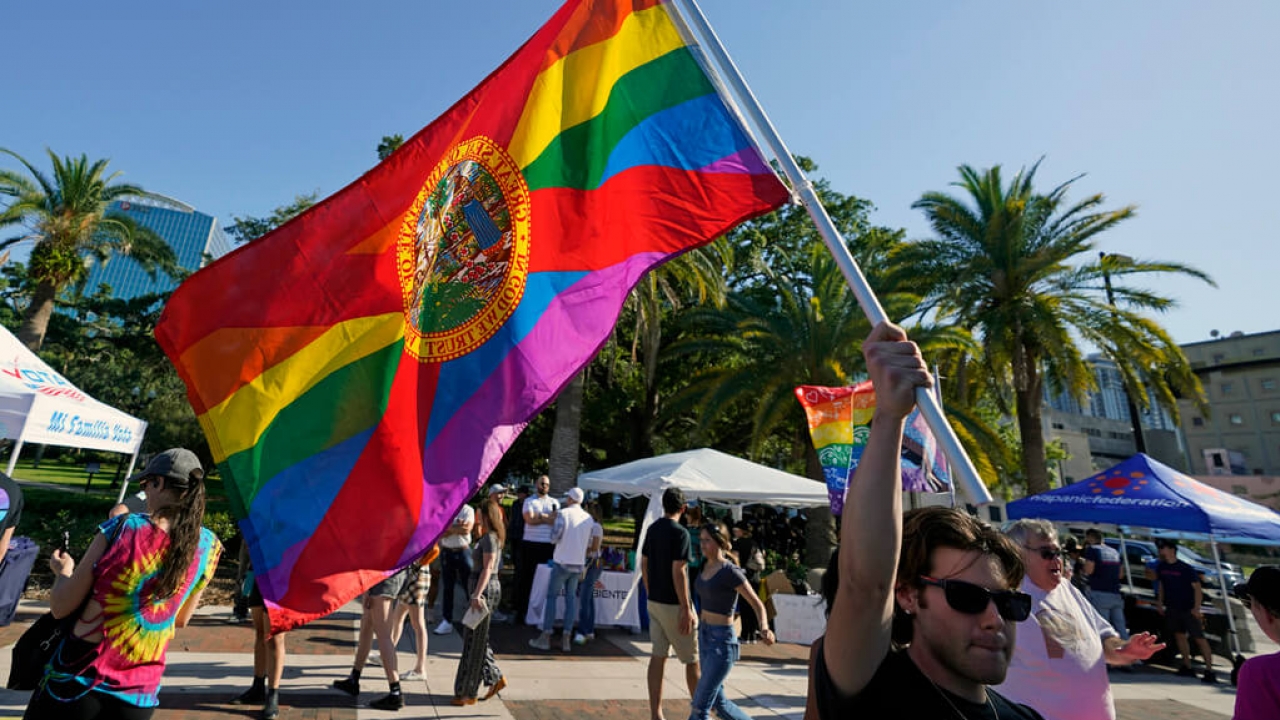A protestor waves a pride flag in Florida