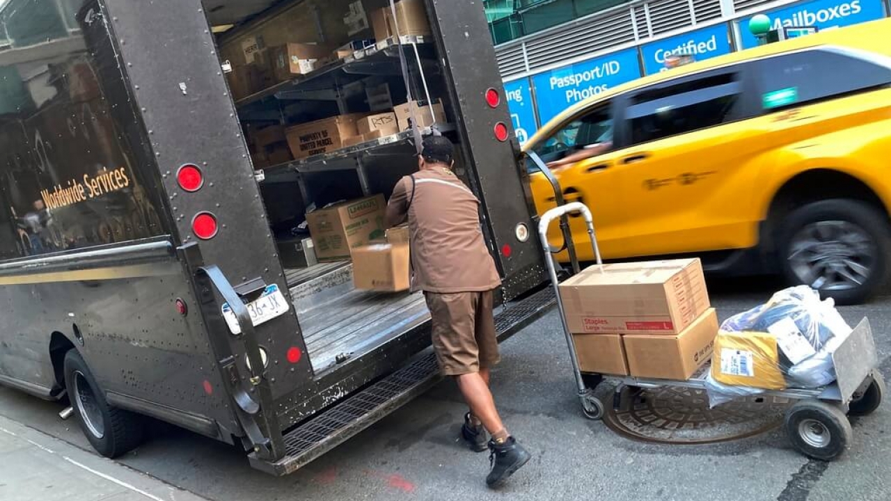 A UPS driver loads a truck in New York