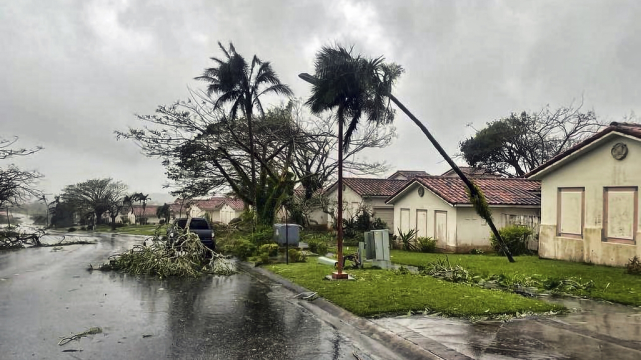 Downed tree branches litter a neighborhood in Yona, Guam.