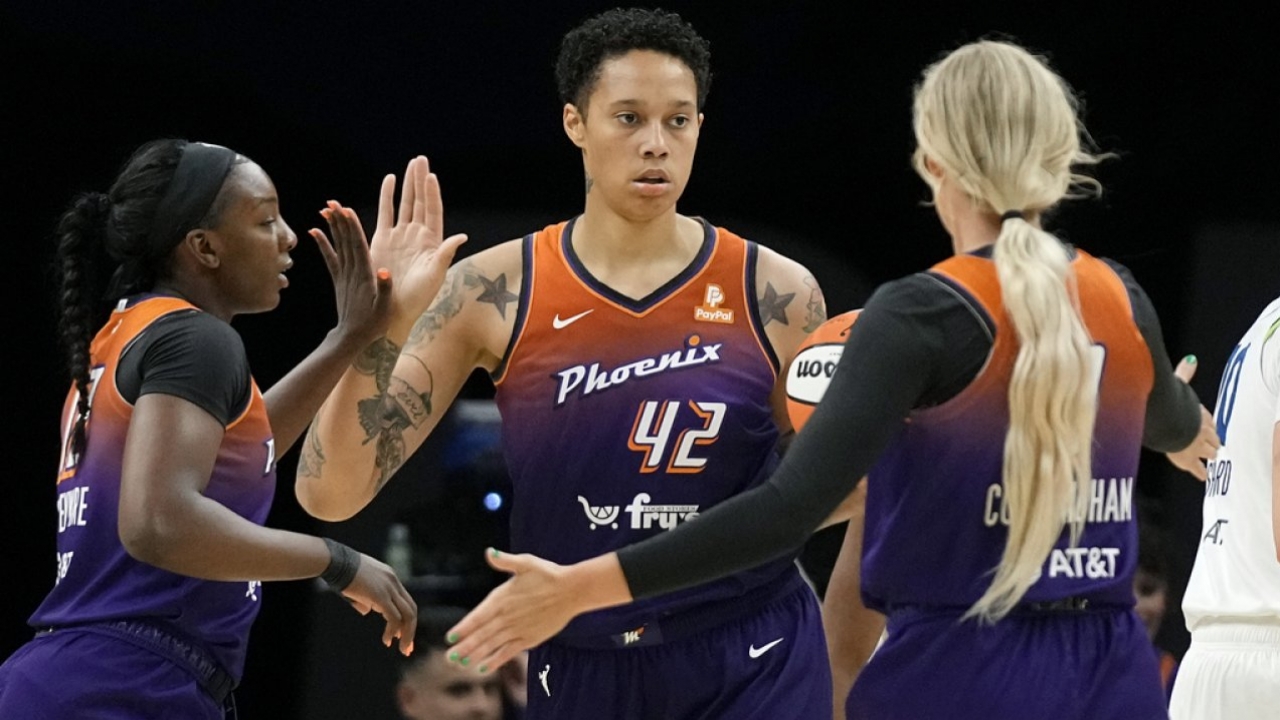 Phoenix Mercury's Brittney Griner celebrates her score with Sophie Cunningham, right, and Michaela Onyenwere, left.
