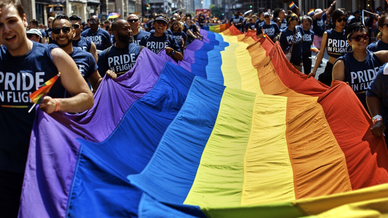 Revelers carry a LTBGQ flag along Fifth Avenue during the New York City Pride Parade.