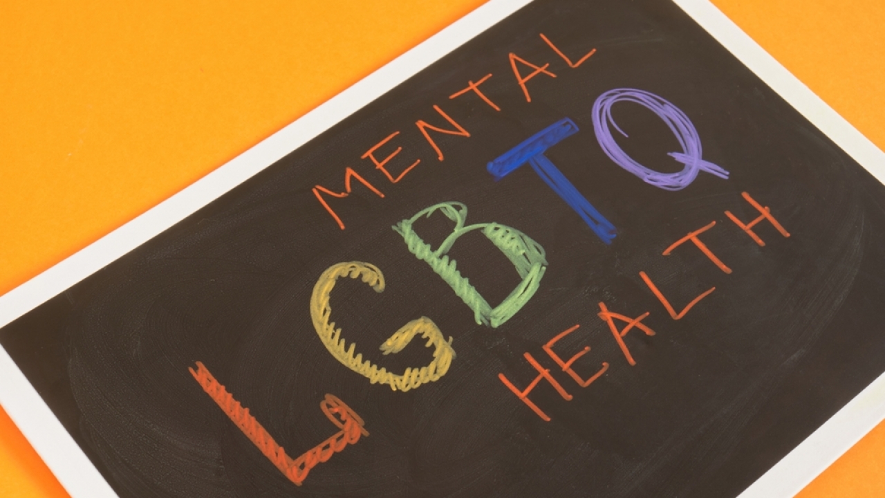 "LGBTQ MENTAL HEALTH" written on chalkboard