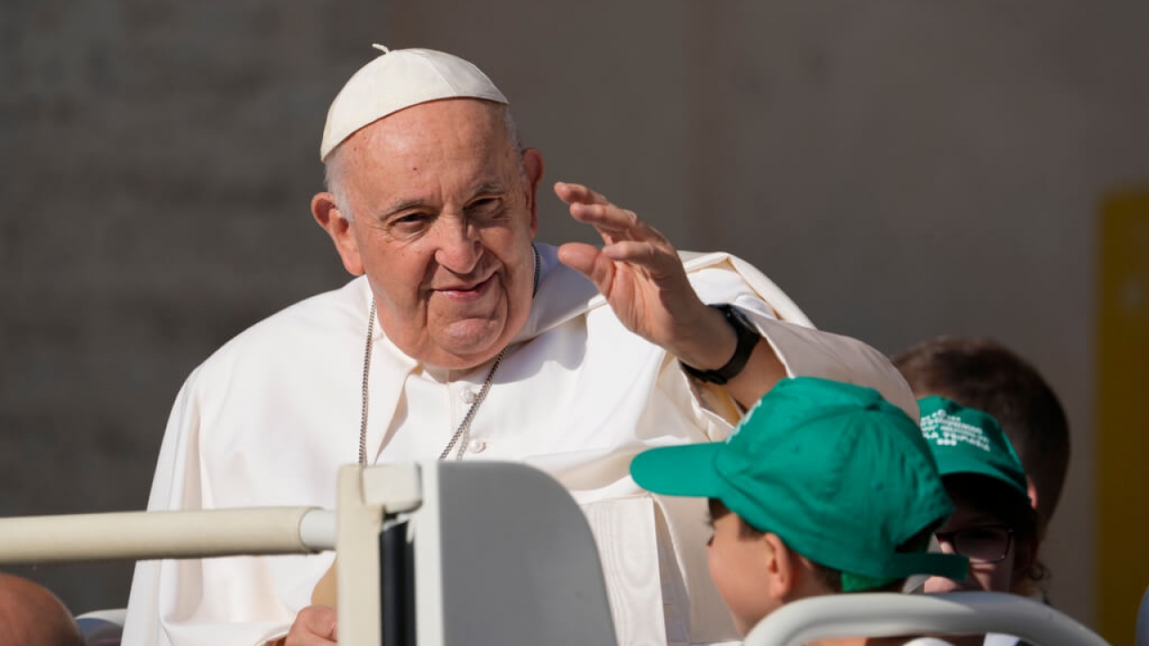 Pope Francis waving.