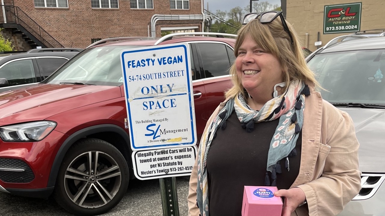 Kendra Arnold, owner of Feasty Vegan, offers parking scofflaws a free cupcake