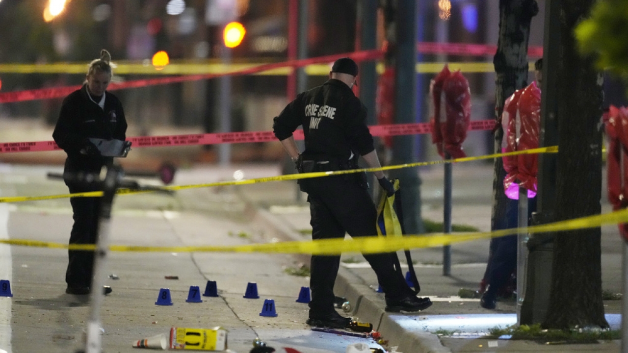 Denver Police Department investigators work the scene of a mass shooting along Market Street in Denver.