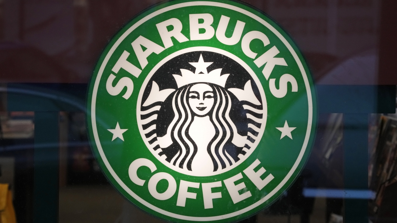 The Starbucks sign is displayed in the window of a Pittsburgh store.