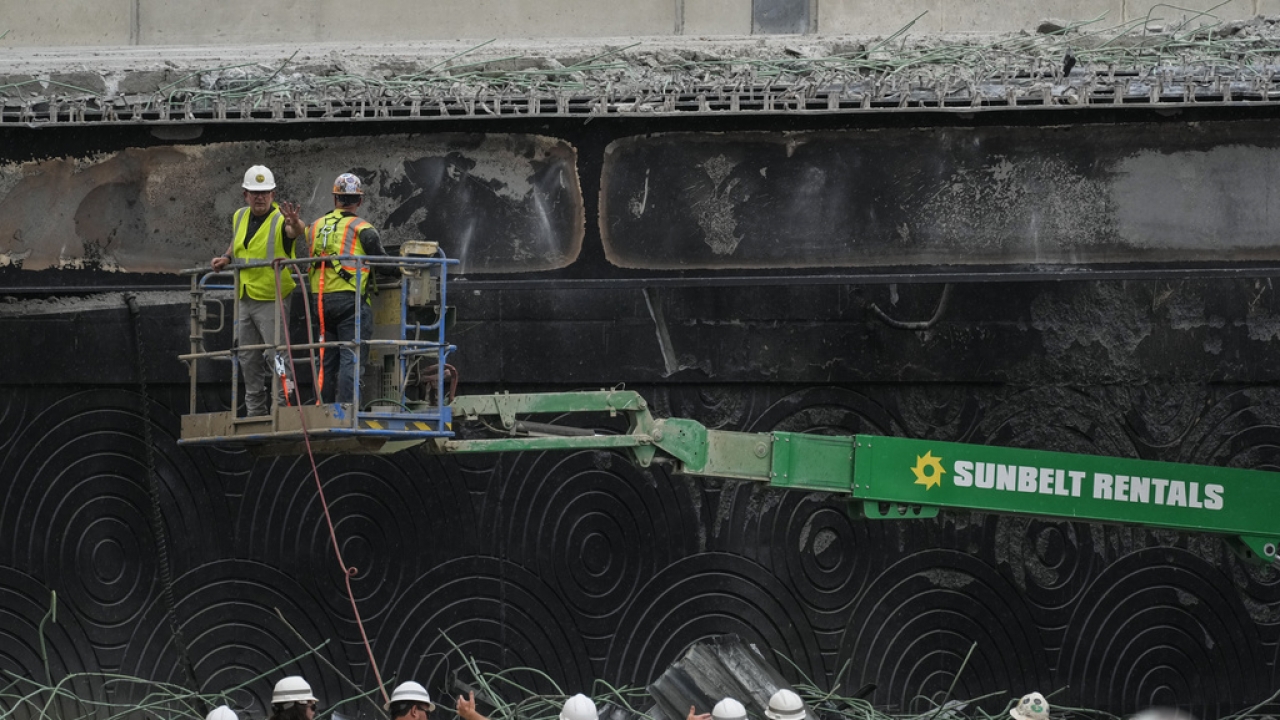 Crews continue to work the scene of a collapsed elevated section of Interstate 95.