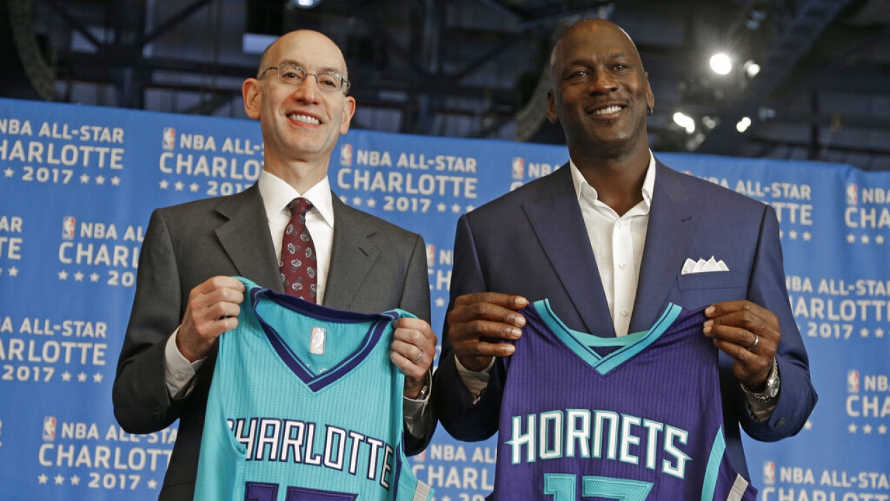 NBA commissioner Adam Silver, left, and Charlotte Hornets owner Michael Jordan, right.