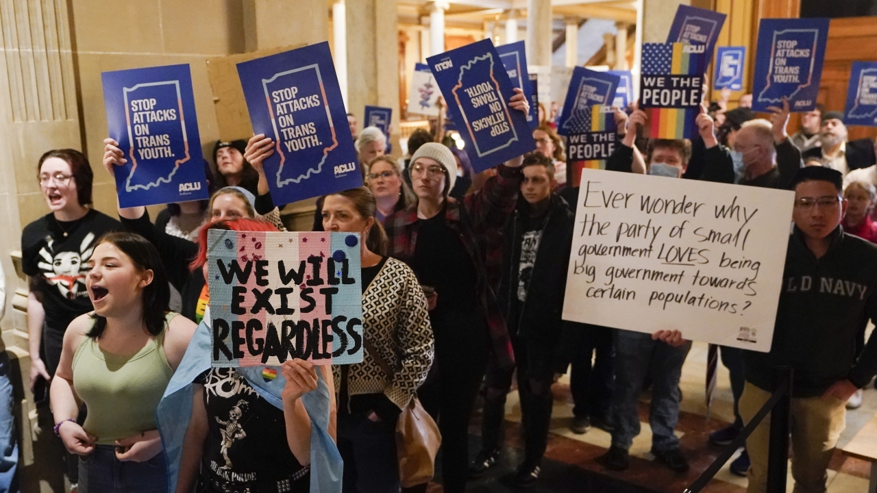 Protesters stand outside of the Senate chamber at the Indiana Statehouse