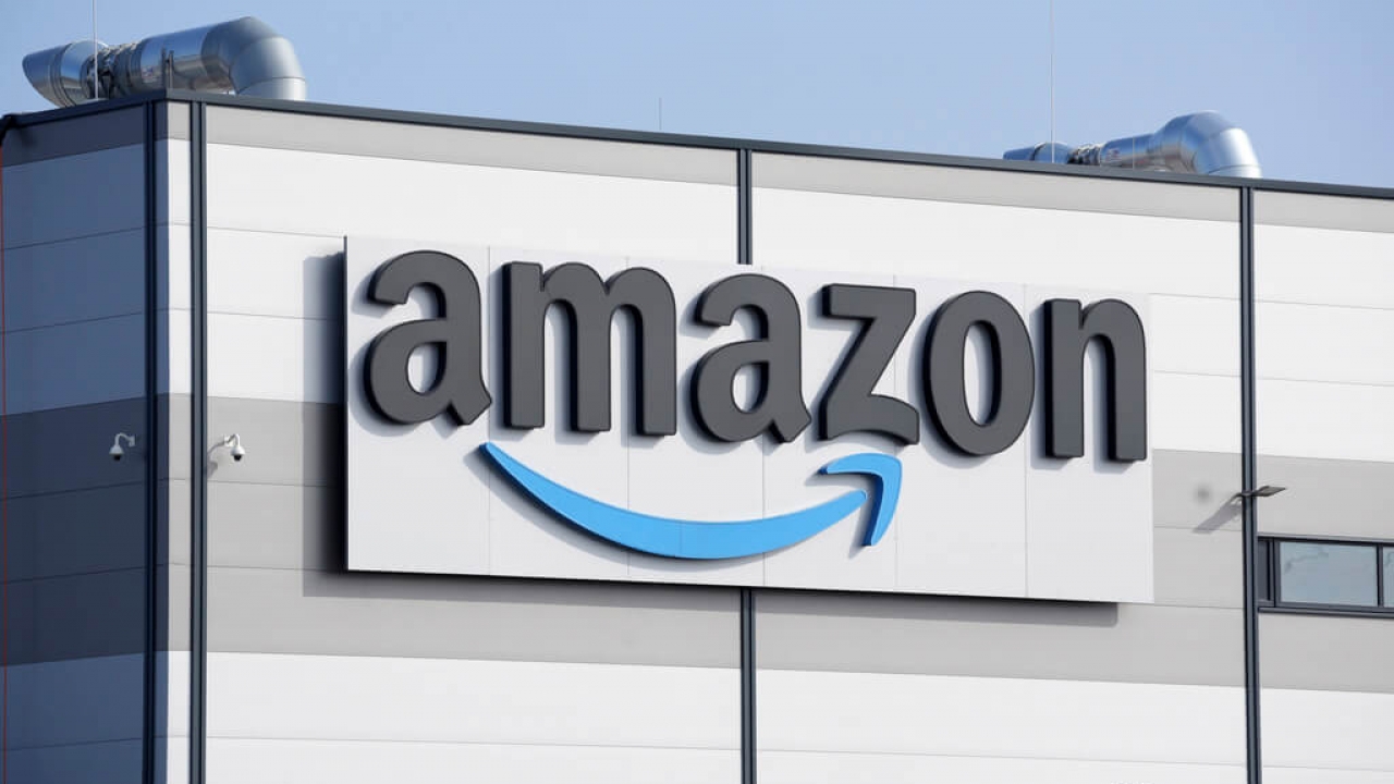 An Amazon company logo is seen on the facade of the company's building.