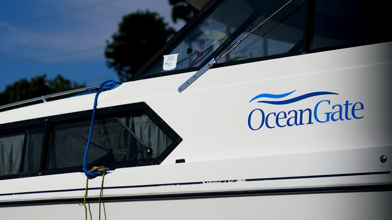A boat with the OceanGate logo is parked on a lot near the OceanGate offices.