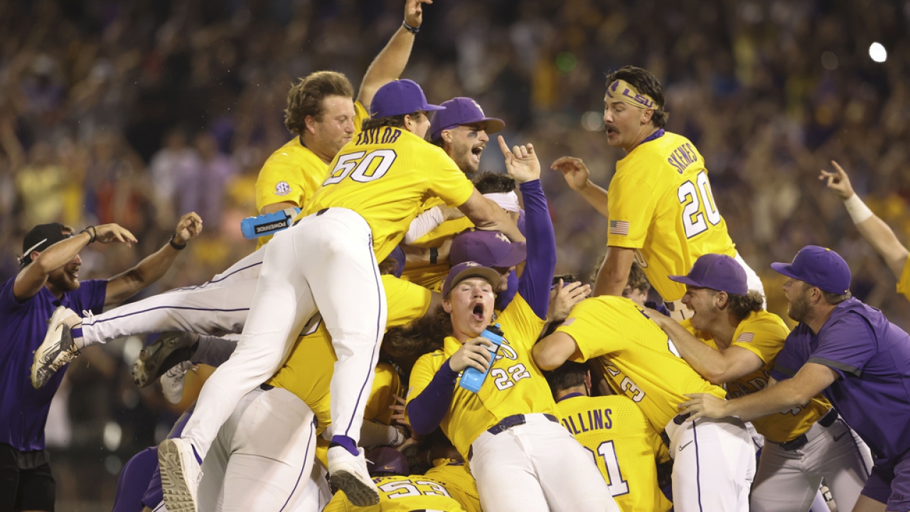 LSU baseball players and coaches celebrate after winning the NCAA College World Series.