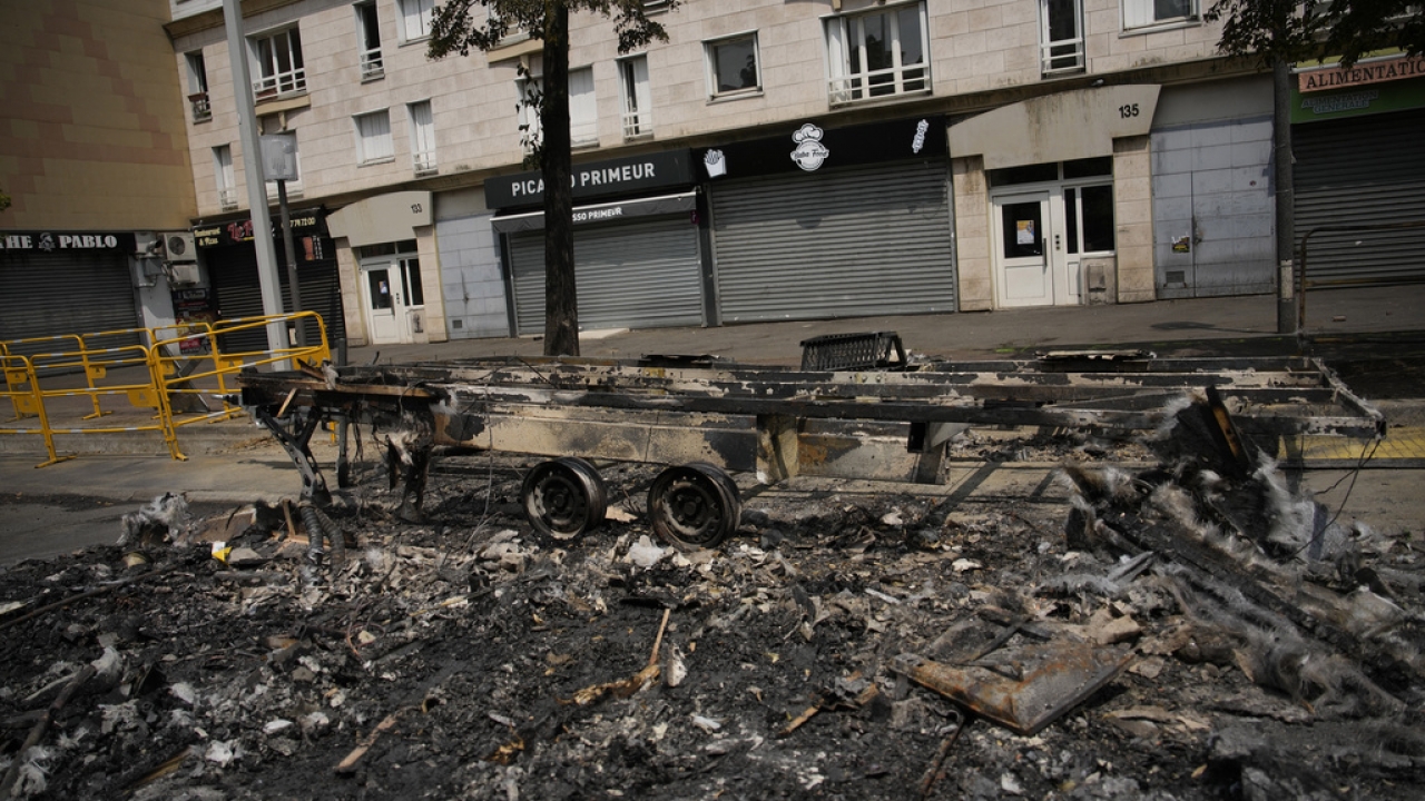 A charred vehicle on a street in France