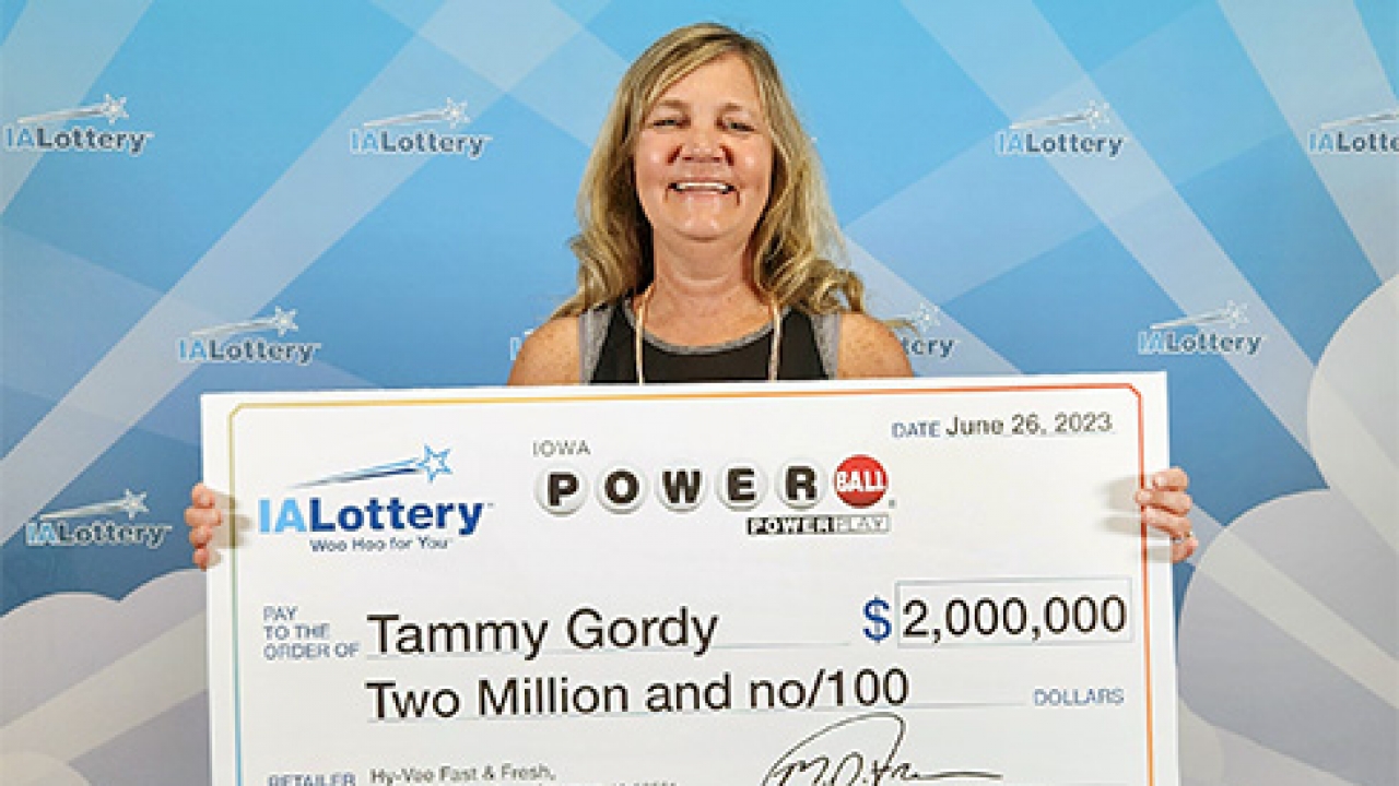 Tammy Gordy holds a novelty check for $2 million.